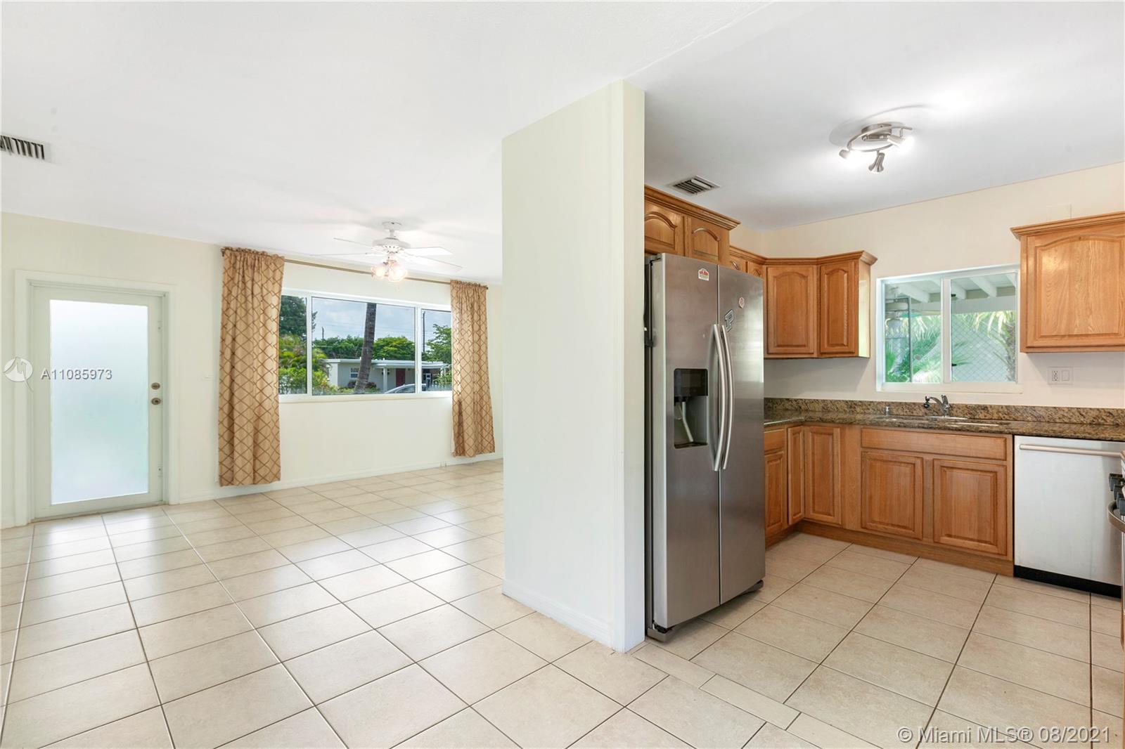 12501 Southwest 84th Avenue Road Miami, FL 33156 - Photo 9 of 20 a kitchen with stainless steel appliances a refrigerator sink and cabinets