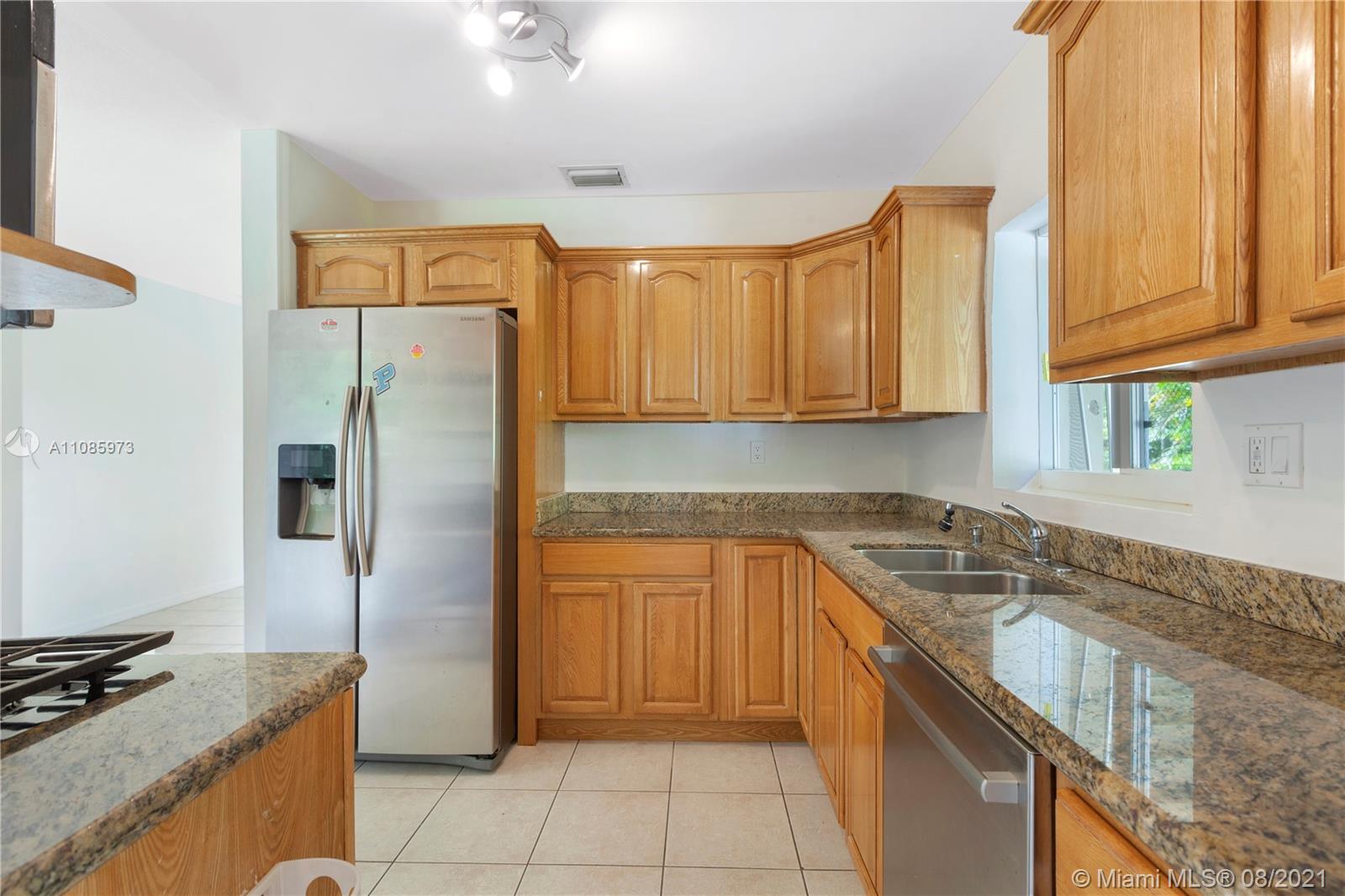 12501 Southwest 84th Avenue Road Miami, FL 33156 - Photo 10 of 20 a kitchen with stainless steel appliances granite countertop a refrigerator and a sink