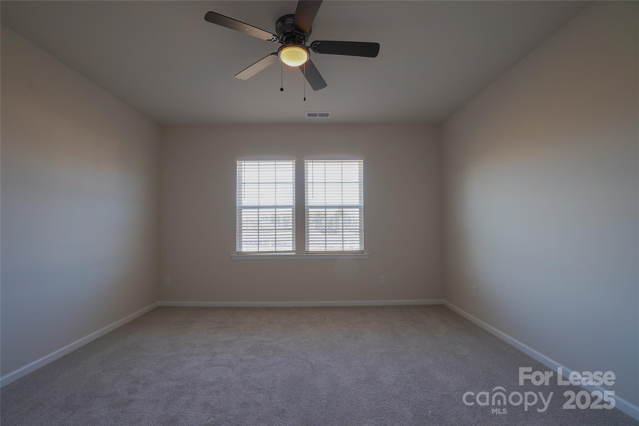 1411 Caracara Court Belmont, NC 28012 - Photo 12 of 29 an empty room with a window and a fan