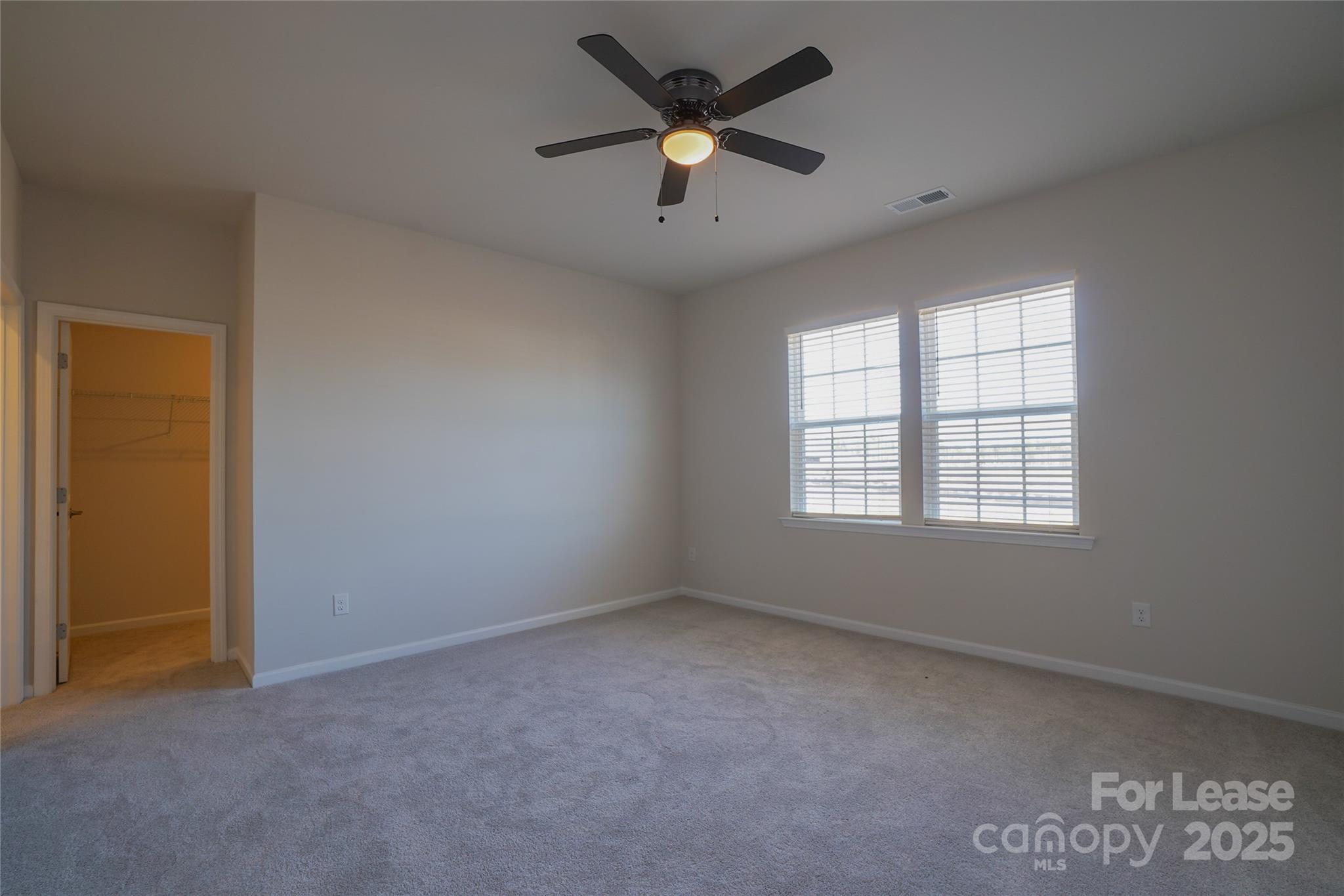 1411 Caracara Court Belmont, NC 28012 - Photo 13 of 29 an empty room with a window and a ceiling fan