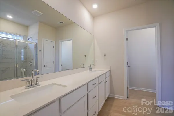 a bathroom with a glass shower door