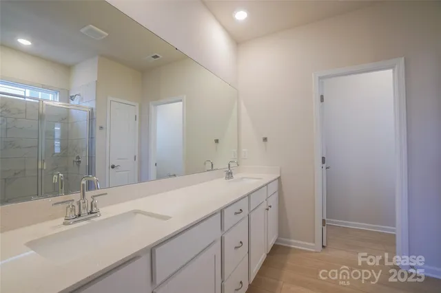 a bathroom with a glass shower door