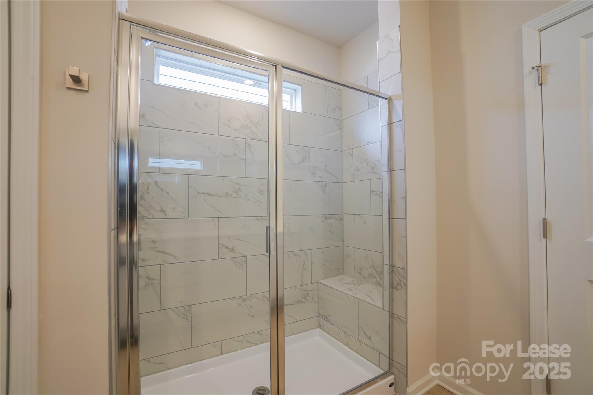 1411 Caracara Court Belmont, NC 28012 - Photo 15 of 29 a bathroom with a glass shower door