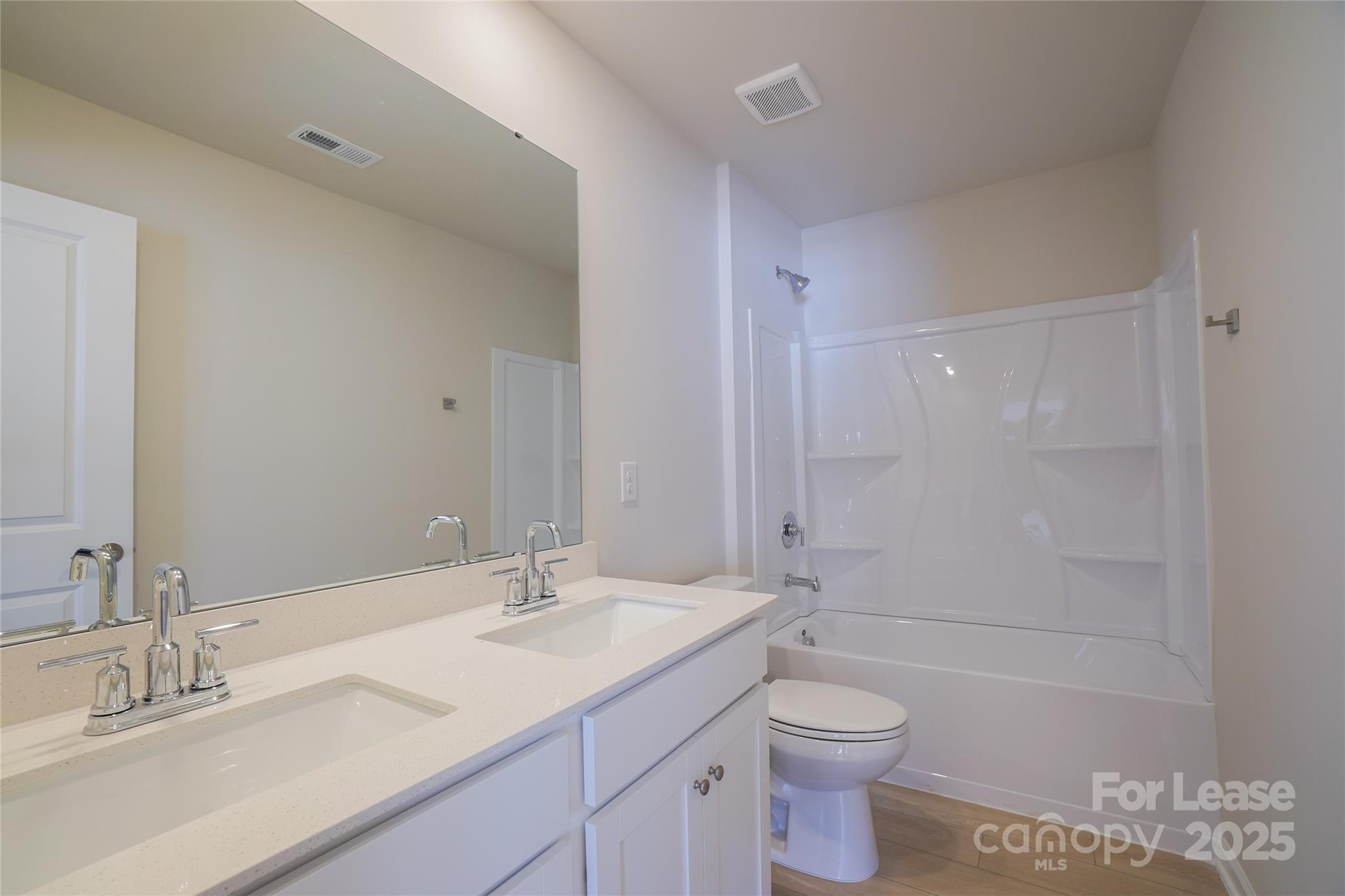 1411 Caracara Court Belmont, NC 28012 - Photo 21 of 29 a bathroom with a granite countertop sink a toilet and shower