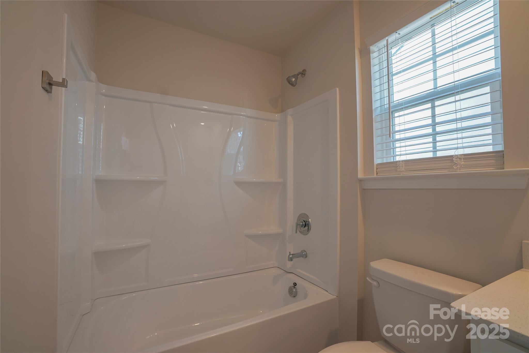 1411 Caracara Court Belmont, NC 28012 - Photo 24 of 29 a bathroom with a bathtub and a toilet