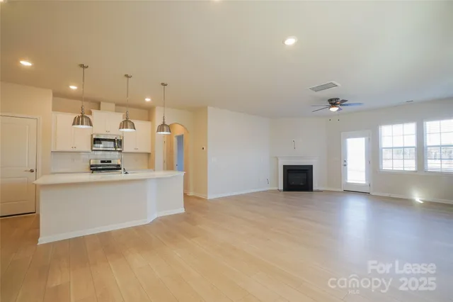 a kitchen with stainless steel appliances granite countertop a sink a stove and a refrigerator