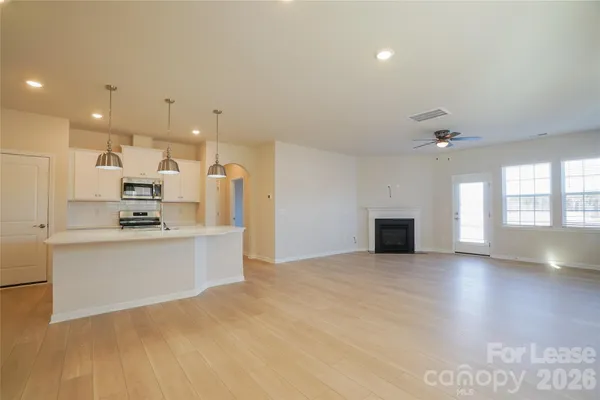 a kitchen with stainless steel appliances granite countertop a sink a stove and a refrigerator