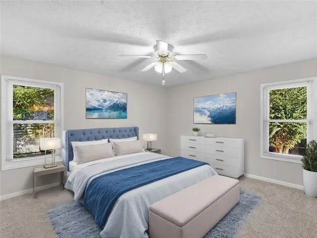 a bedroom with a large bed and a window