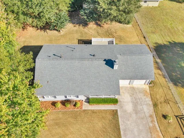a view of house with a yard
