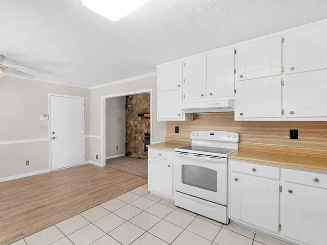 a kitchen with white cabinets and white appliances