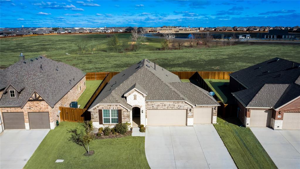 an aerial view of a house with a yard swimming pool and outdoor seating