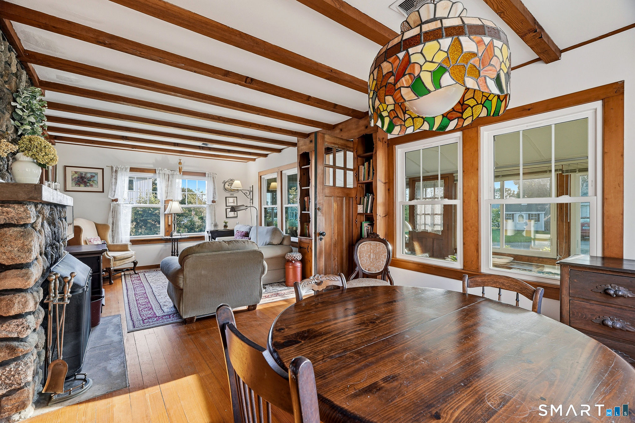 311 Brightwater Road Old Lyme, CT 06371 - Photo 13 of 39 Dining room and living room with stone fireplace