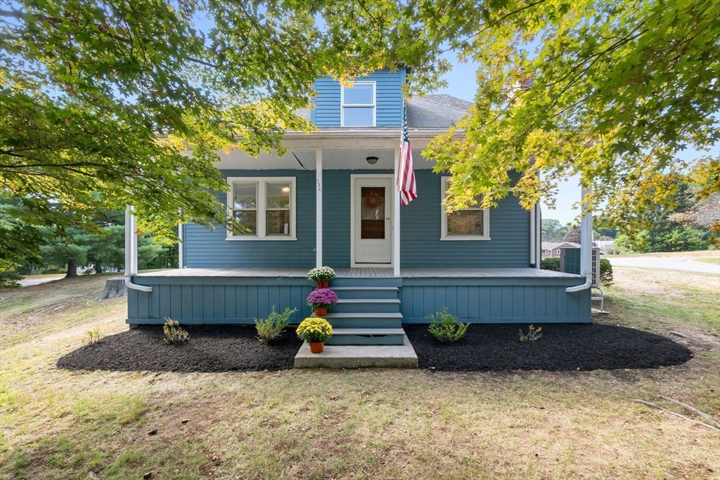 a view of a house with a backyard and a tree