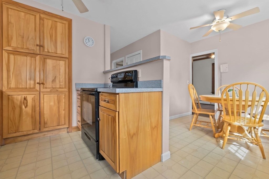 326 William Street Stoneham, MA 02180 - Photo 14 of 39 a view of a kitchen with furniture fridge and wooden floor
