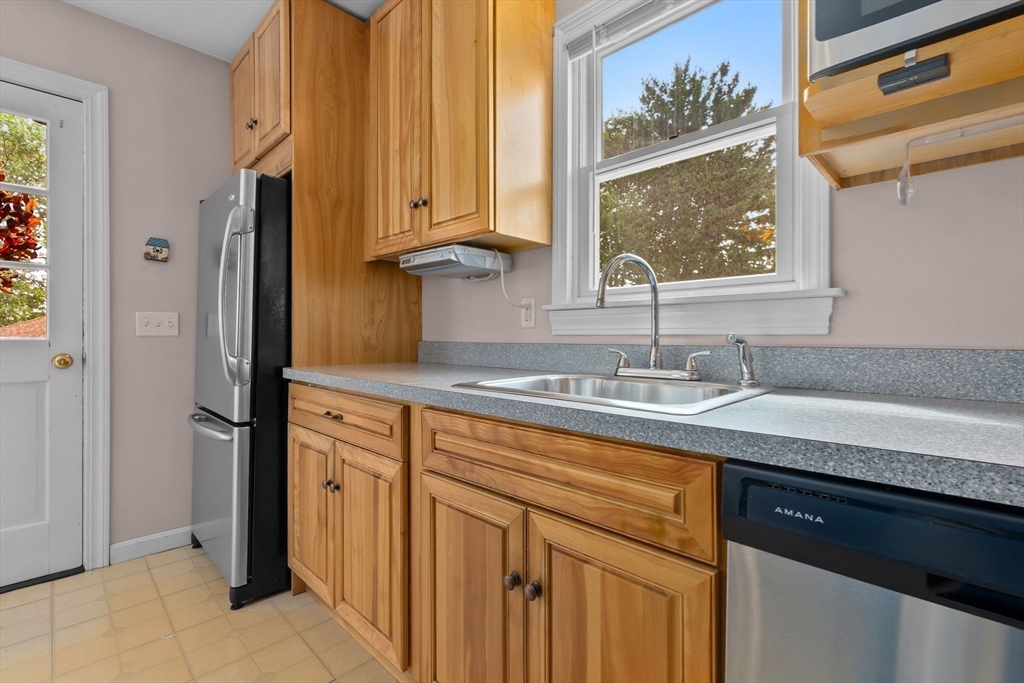 326 William Street Stoneham, MA 02180 - Photo 15 of 39 a kitchen with stainless steel appliances granite countertop a sink and a cabinets