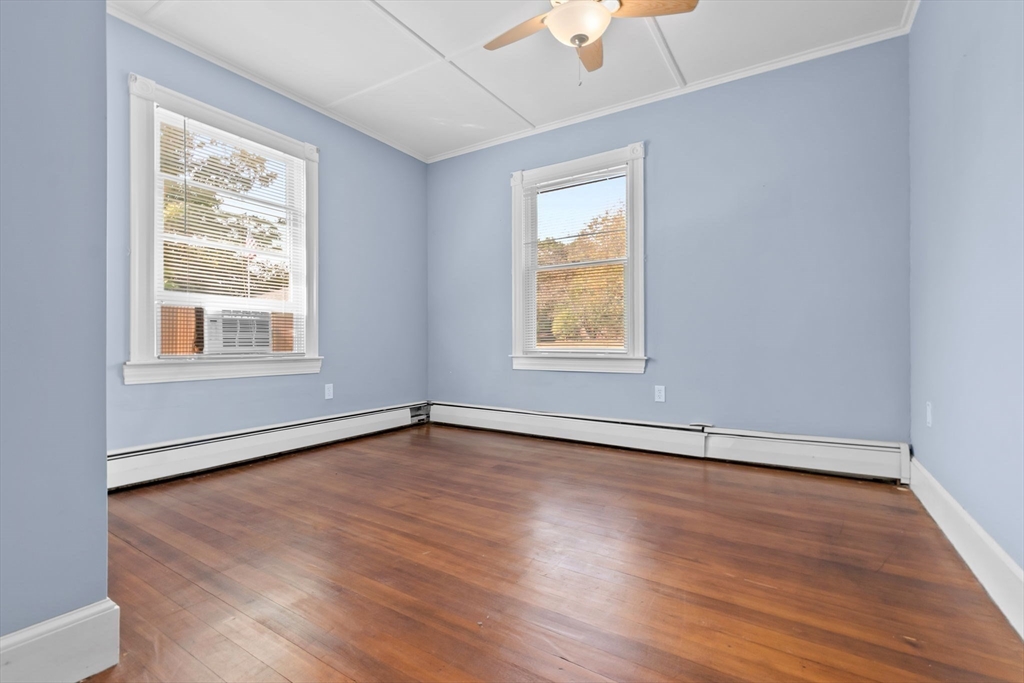 326 William Street Stoneham, MA 02180 - Photo 17 of 39 an empty room with wooden floor and windows