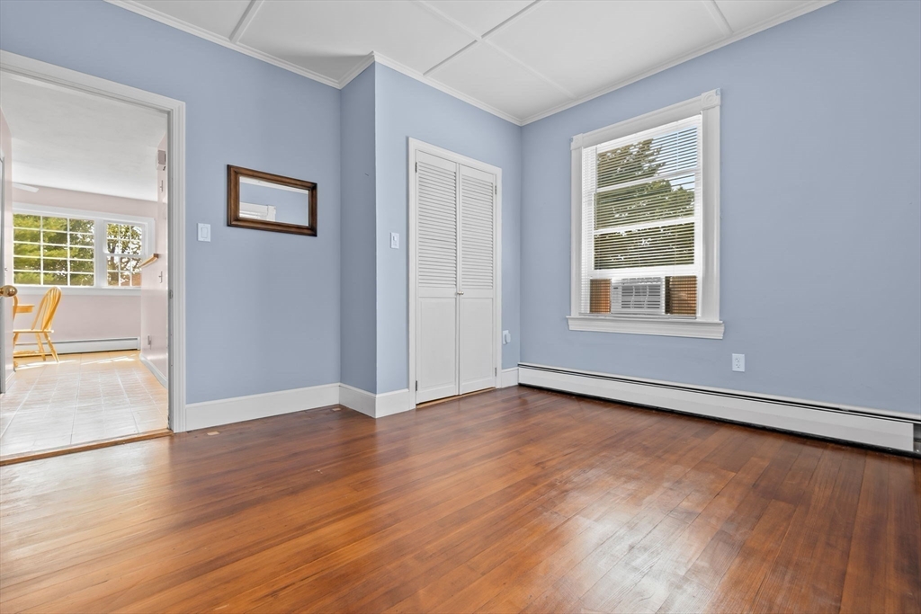 326 William Street Stoneham, MA 02180 - Photo 18 of 39 an empty room with wooden floor and windows