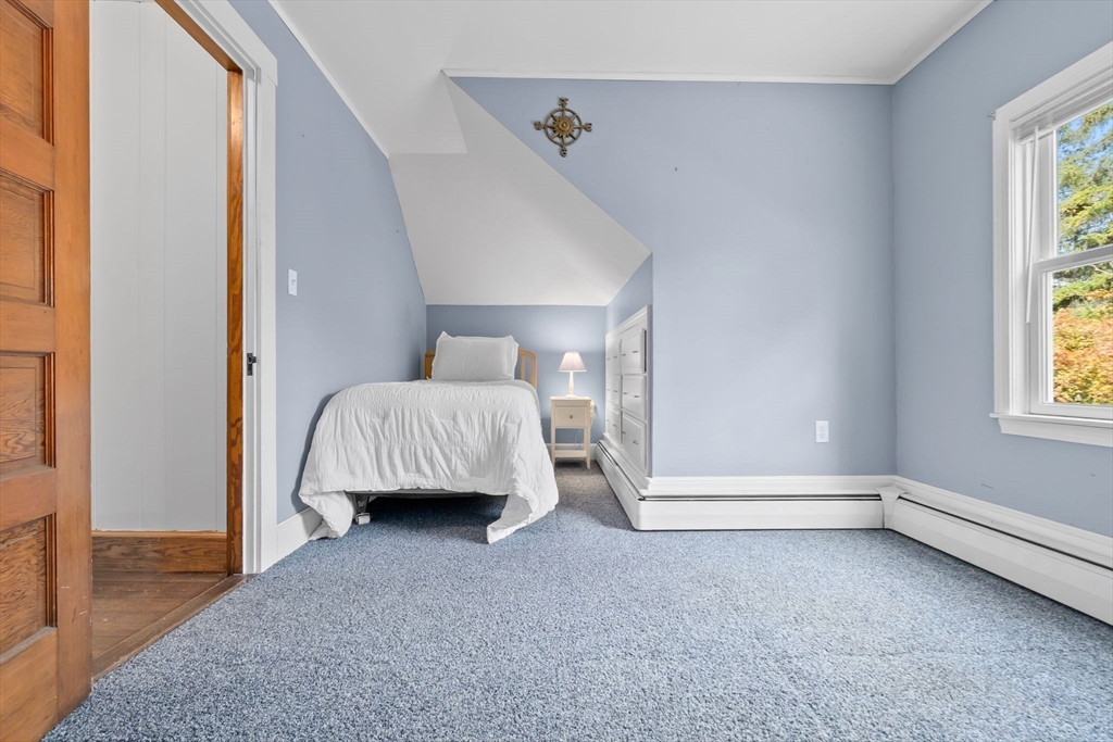 326 William Street Stoneham, MA 02180 - Photo 19 of 39 a living room with a bed and a window