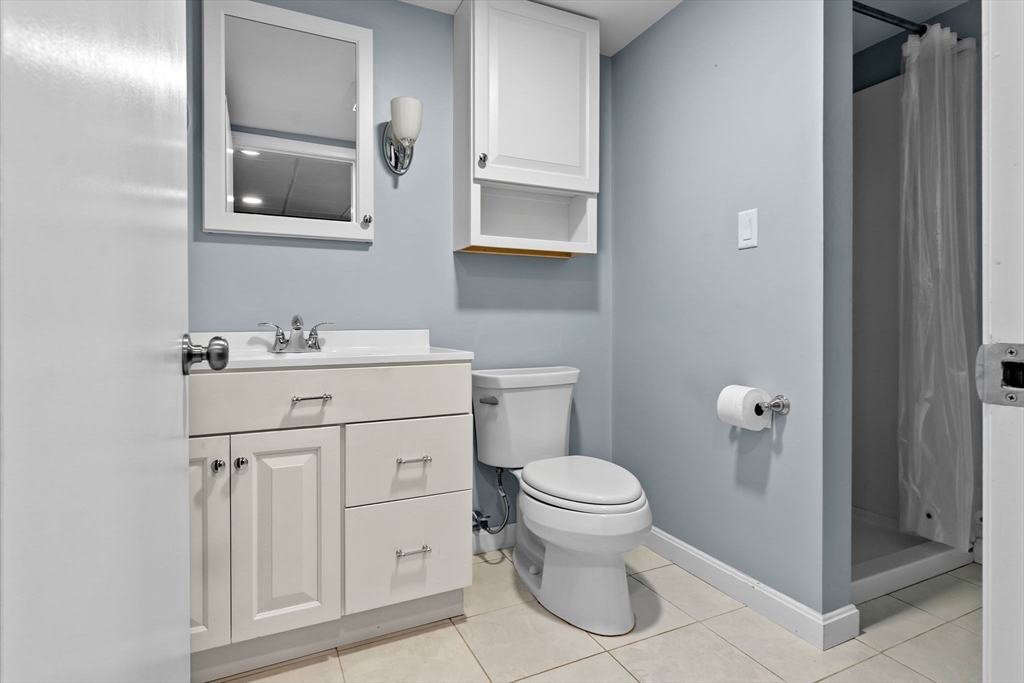 326 William Street Stoneham, MA 02180 - Photo 28 of 39 a bathroom with a sink a toilet and shower