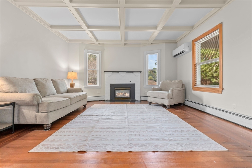 326 William Street Stoneham, MA 02180 - Photo 4 of 39 a living room with furniture and a fireplace