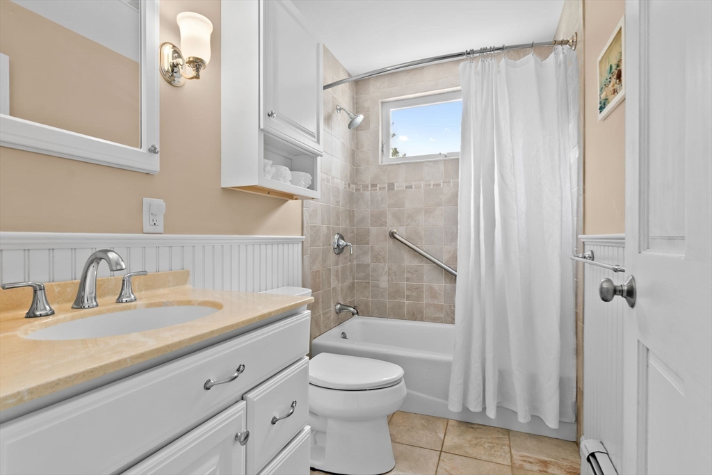 326 William Street Stoneham, MA 02180 - Photo 9 of 39 a bathroom with a sink a toilet and shower