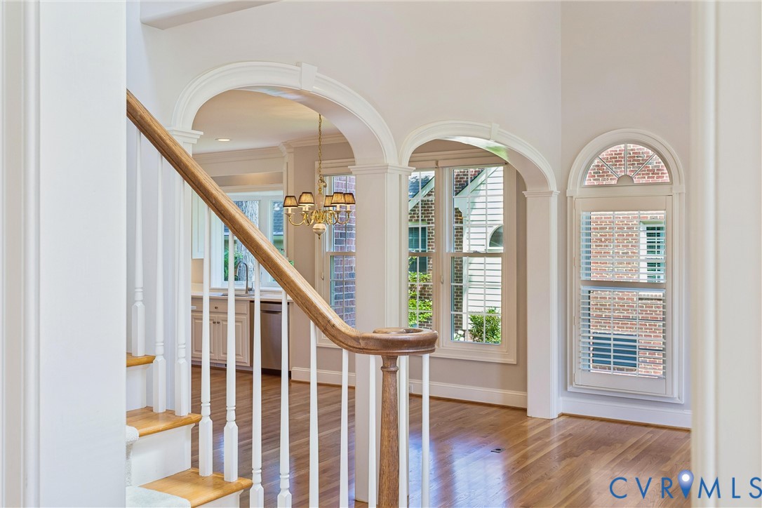 3009 Travis Pond Road Williamsburg, VA 23185 - Photo 21 of 100 Hardwood staircase with white balusters and a poli