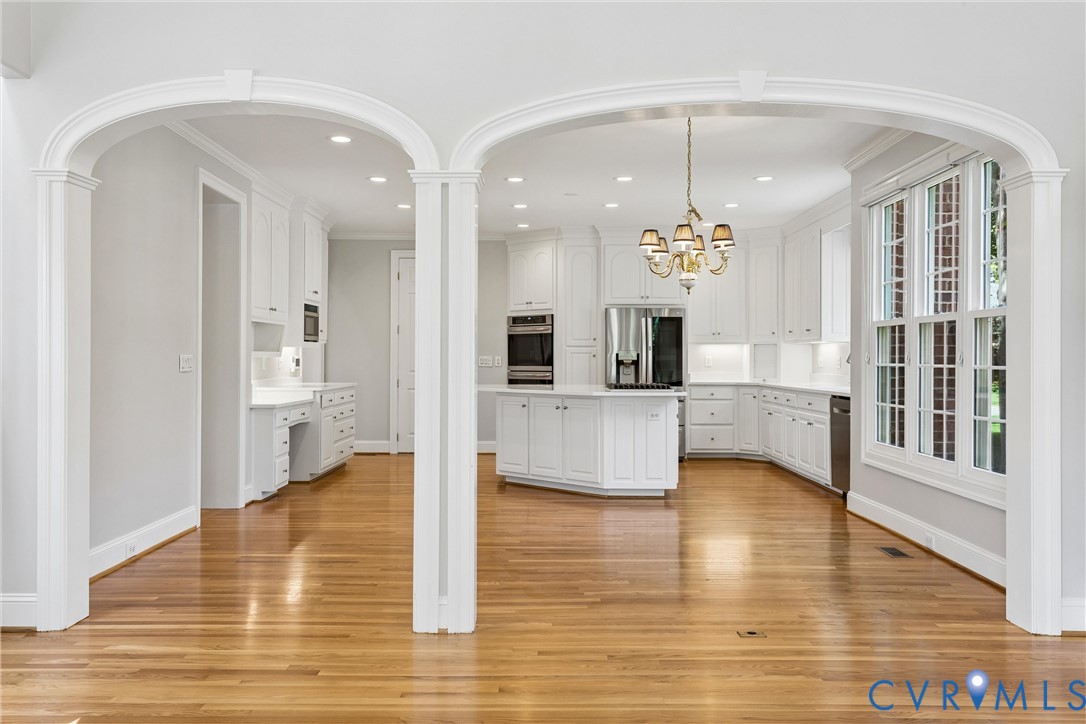 3009 Travis Pond Road Williamsburg, VA 23185 - Photo 27 of 100 Archways framing a kitchen featuring white cabinet
