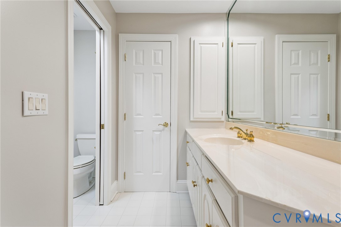 3009 Travis Pond Road Williamsburg, VA 23185 - Photo 61 of 100 Bathroom vanity featuring an integrated sink, poli