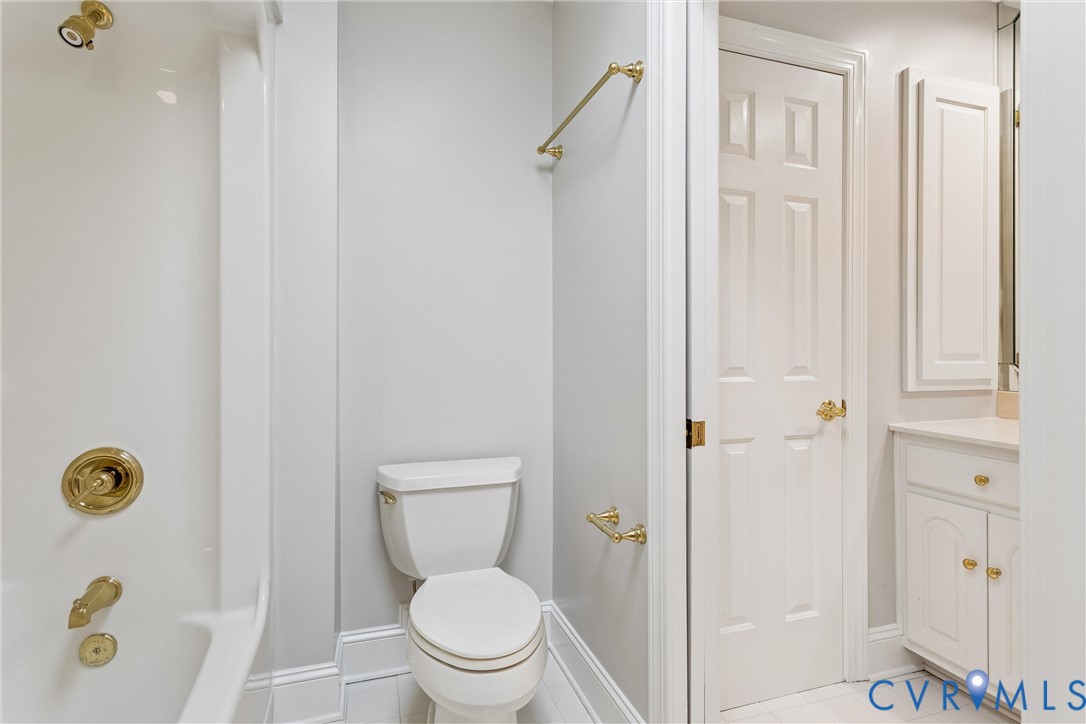 3009 Travis Pond Road Williamsburg, VA 23185 - Photo 62 of 100 Bathroom featuring a white tub with gold-tone fixt