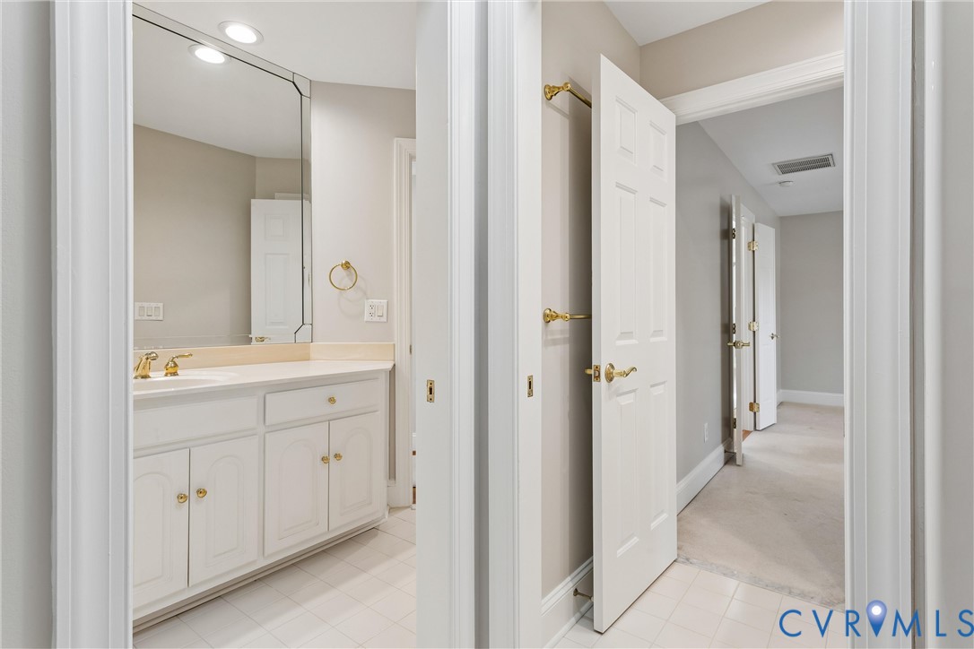 3009 Travis Pond Road Williamsburg, VA 23185 - Photo 63 of 100 Bathroom featuring a white vanity with gold-tone h