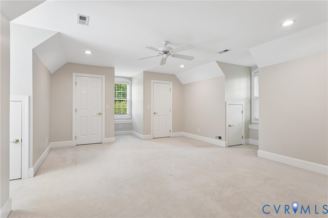 3009 Travis Pond Road Williamsburg, VA 23185 - Photo 64 of 100 Expansive carpeted room featuring vaulted ceilings