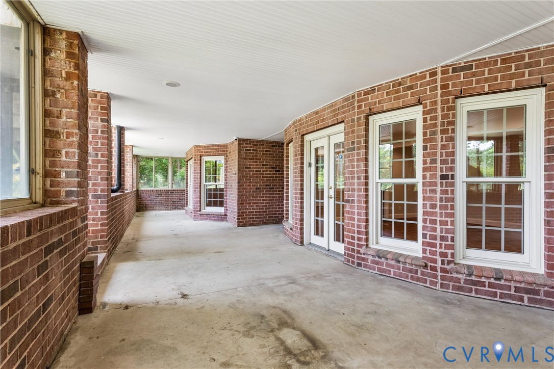 3009 Travis Pond Road Williamsburg, VA 23185 - Photo 73 of 100 Expansive covered patio featuring a concrete floor