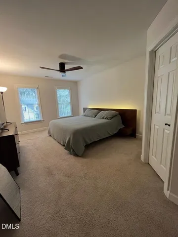a bedroom with a bed and a walk in closet