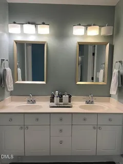 a bathroom with a double vanity sink and mirror