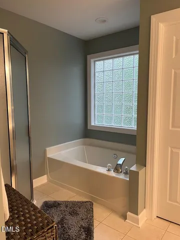 a bath tub sitting in a bathroom next to a window