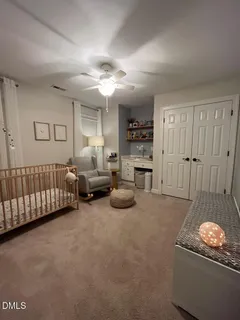 a bed room with furniture and a ceiling fan