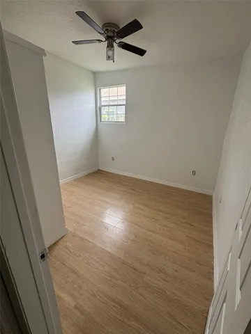 a view of a livingroom with wooden floor and window