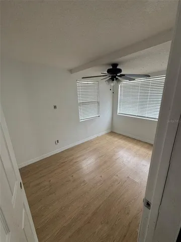 an empty room with windows and closet