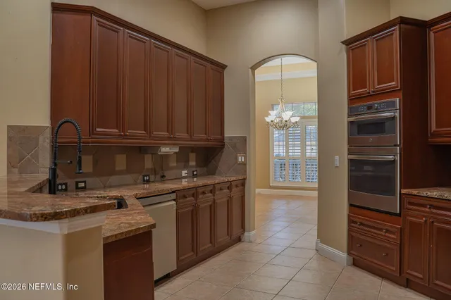 a kitchen with a refrigerator and a stove