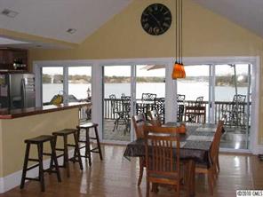 2069 Marquesas Avenue Tega Cay, SC 29708 - Photo 2 of 16 a dining room with furniture a chandelier and wooden floor
