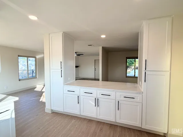 a large kitchen with kitchen island a sink stainless steel appliances and cabinets