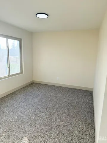 a bathroom with a granite countertop bathtub shower and toilet