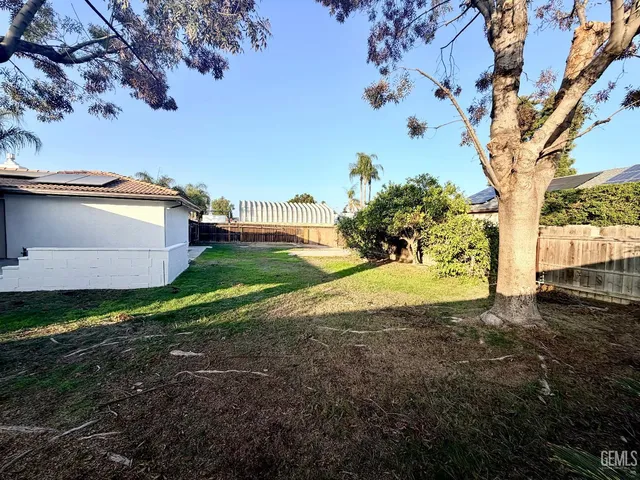a view of a house with a wooden bench