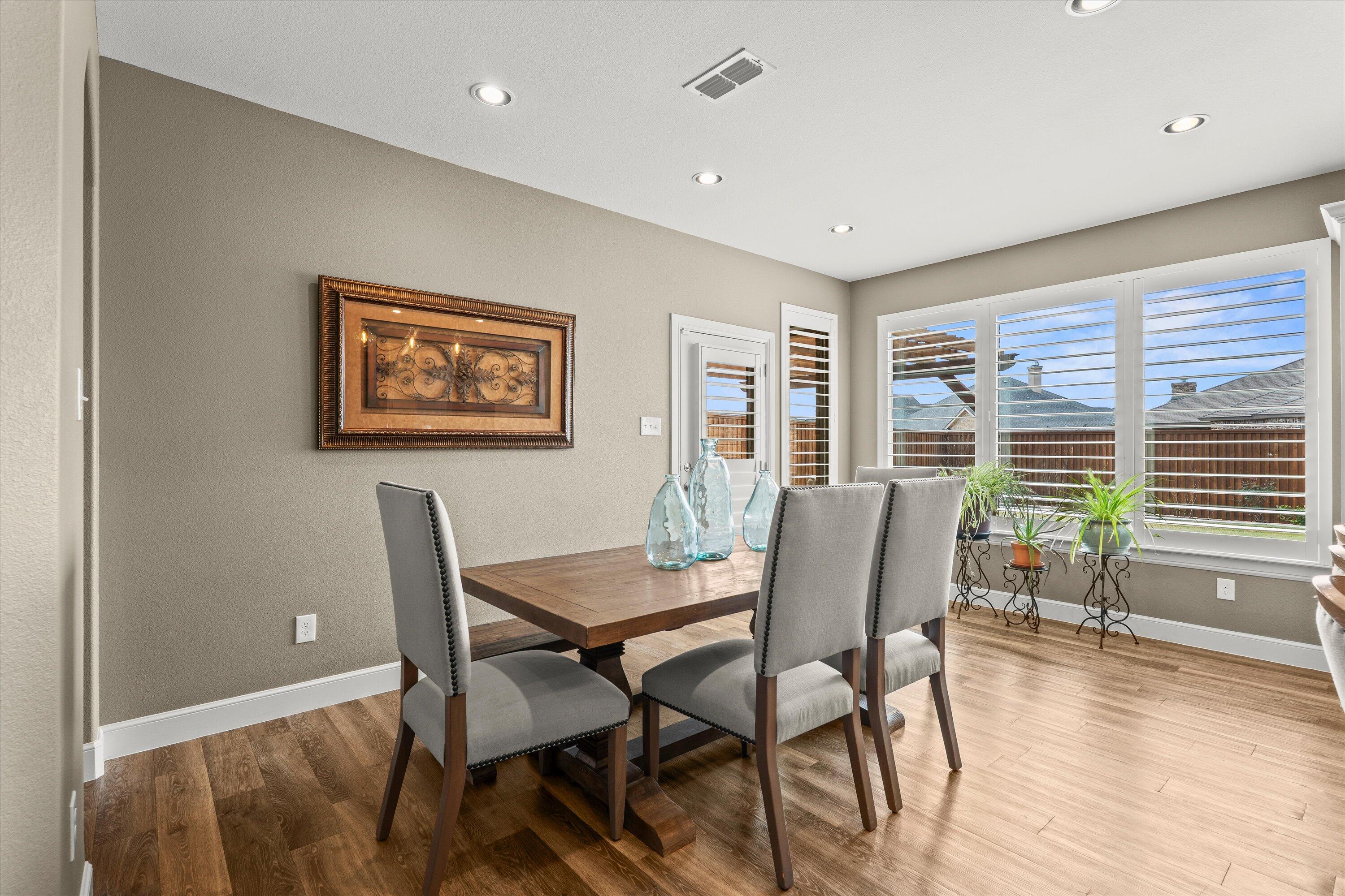 7033 101st Street Lubbock, TX 79424 - Photo 12 of 38 a view of a dining room with furniture window and wooden floor