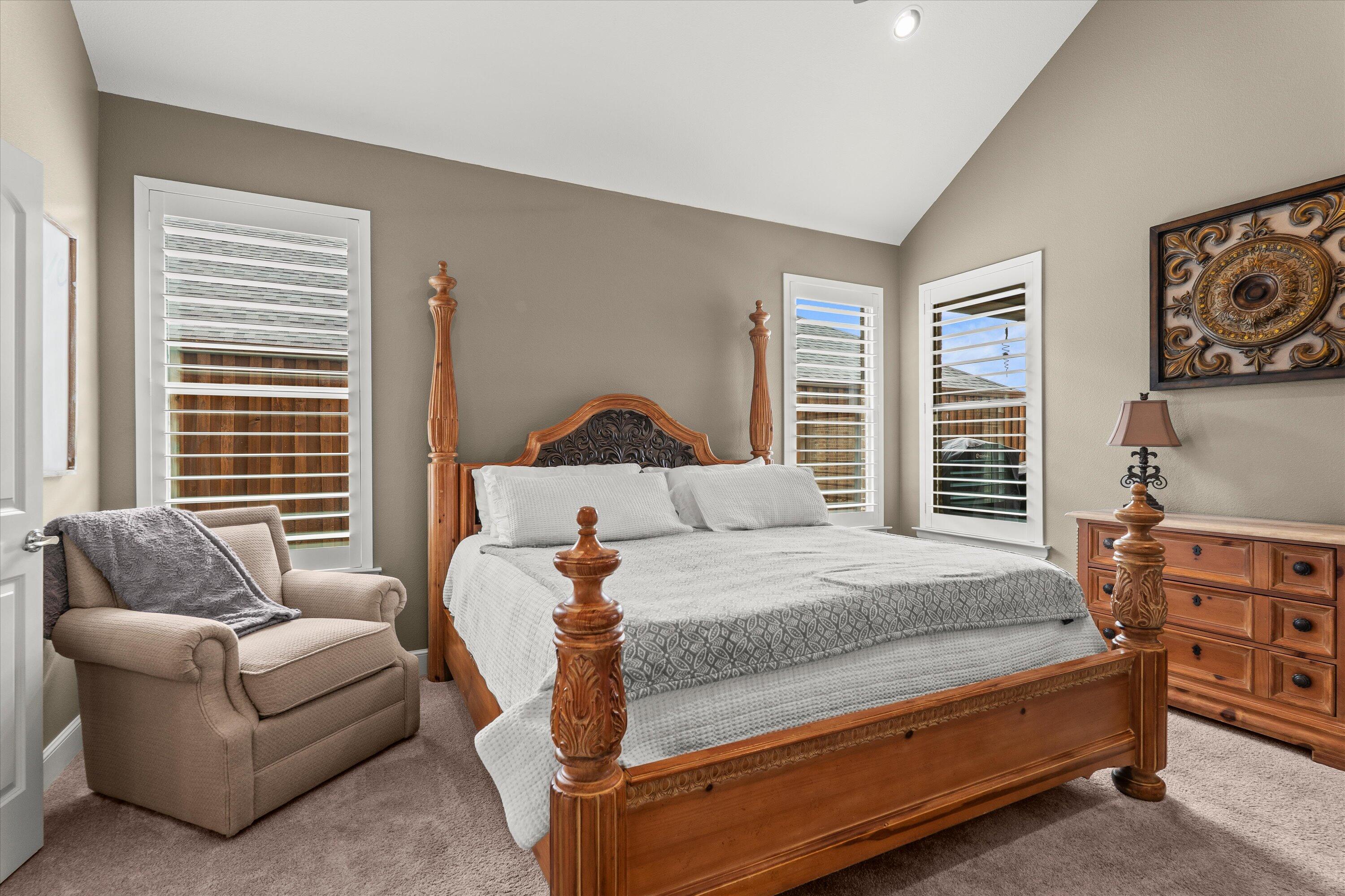 7033 101st Street Lubbock, TX 79424 - Photo 14 of 38 a bedroom with a bed and a couch