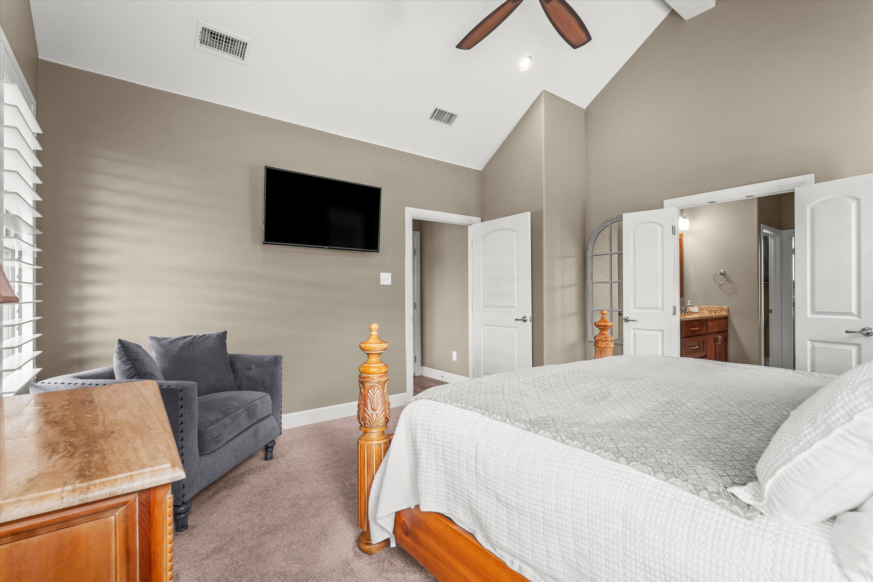 7033 101st Street Lubbock, TX 79424 - Photo 15 of 38 a bedroom with a bed and a couch