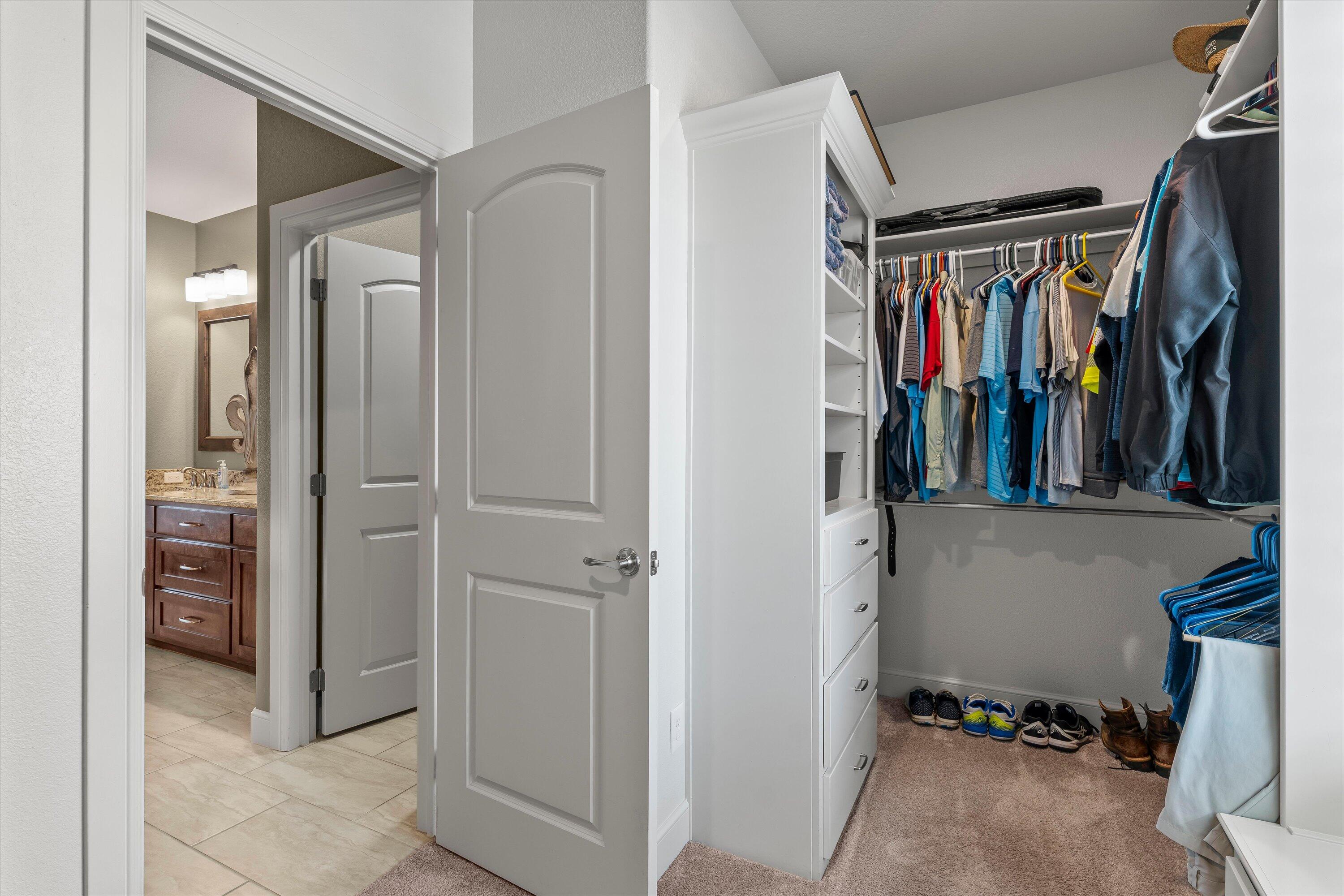7033 101st Street Lubbock, TX 79424 - Photo 20 of 38 a view of walk in closet with clothes and shoes