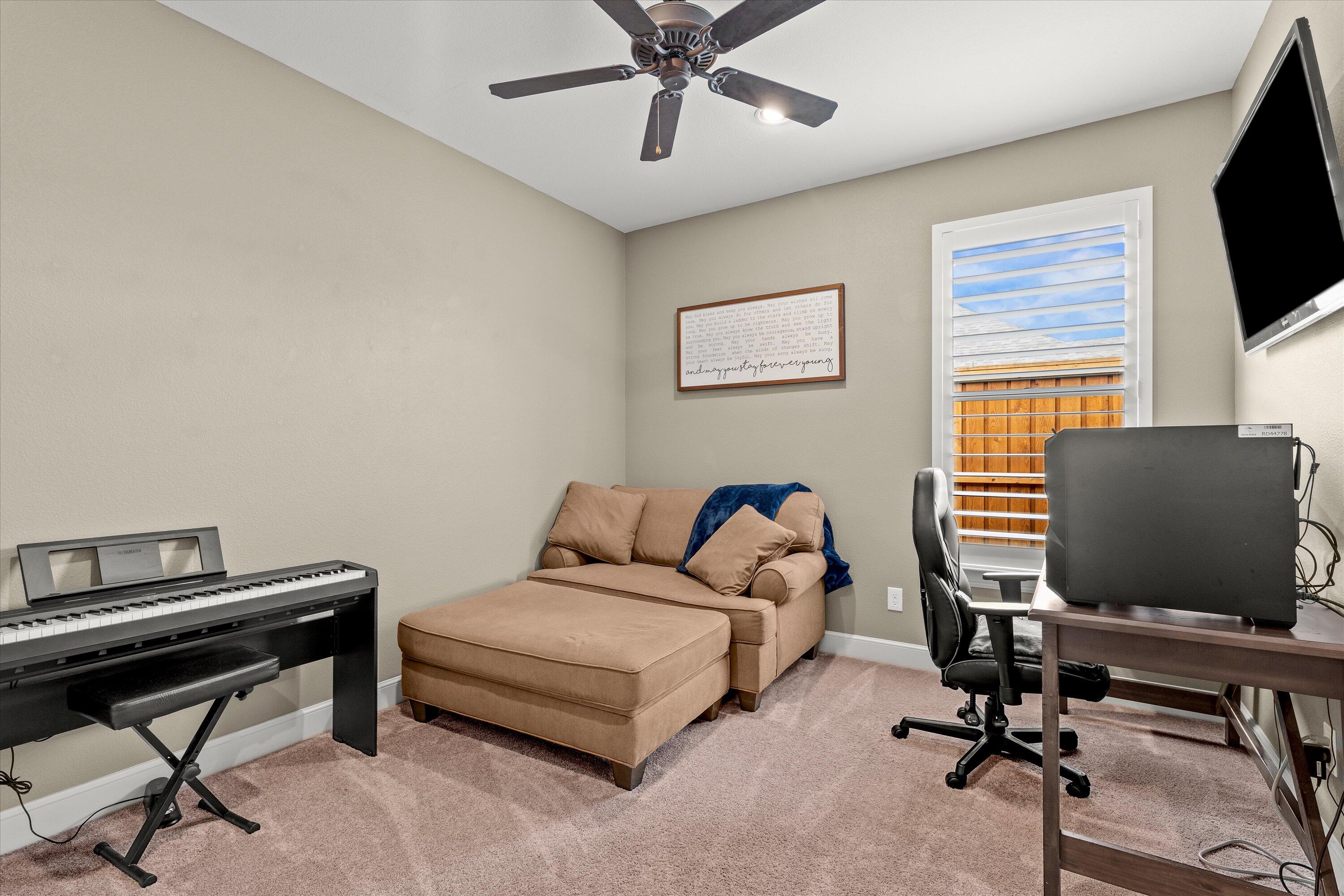 7033 101st Street Lubbock, TX 79424 - Photo 21 of 38 a living room with furniture and a flat screen tv