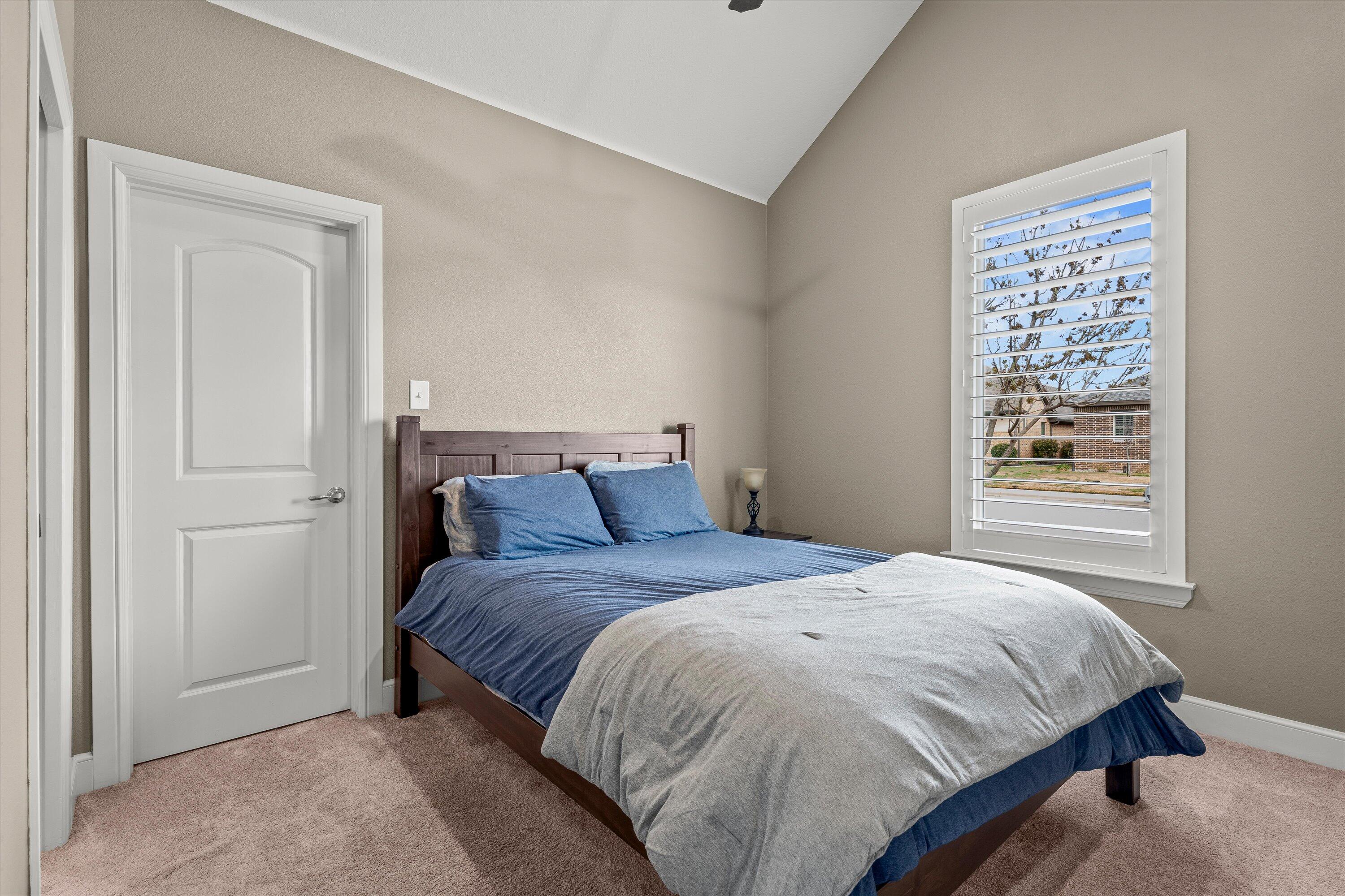 7033 101st Street Lubbock, TX 79424 - Photo 25 of 38 a bedroom with a bed and a window