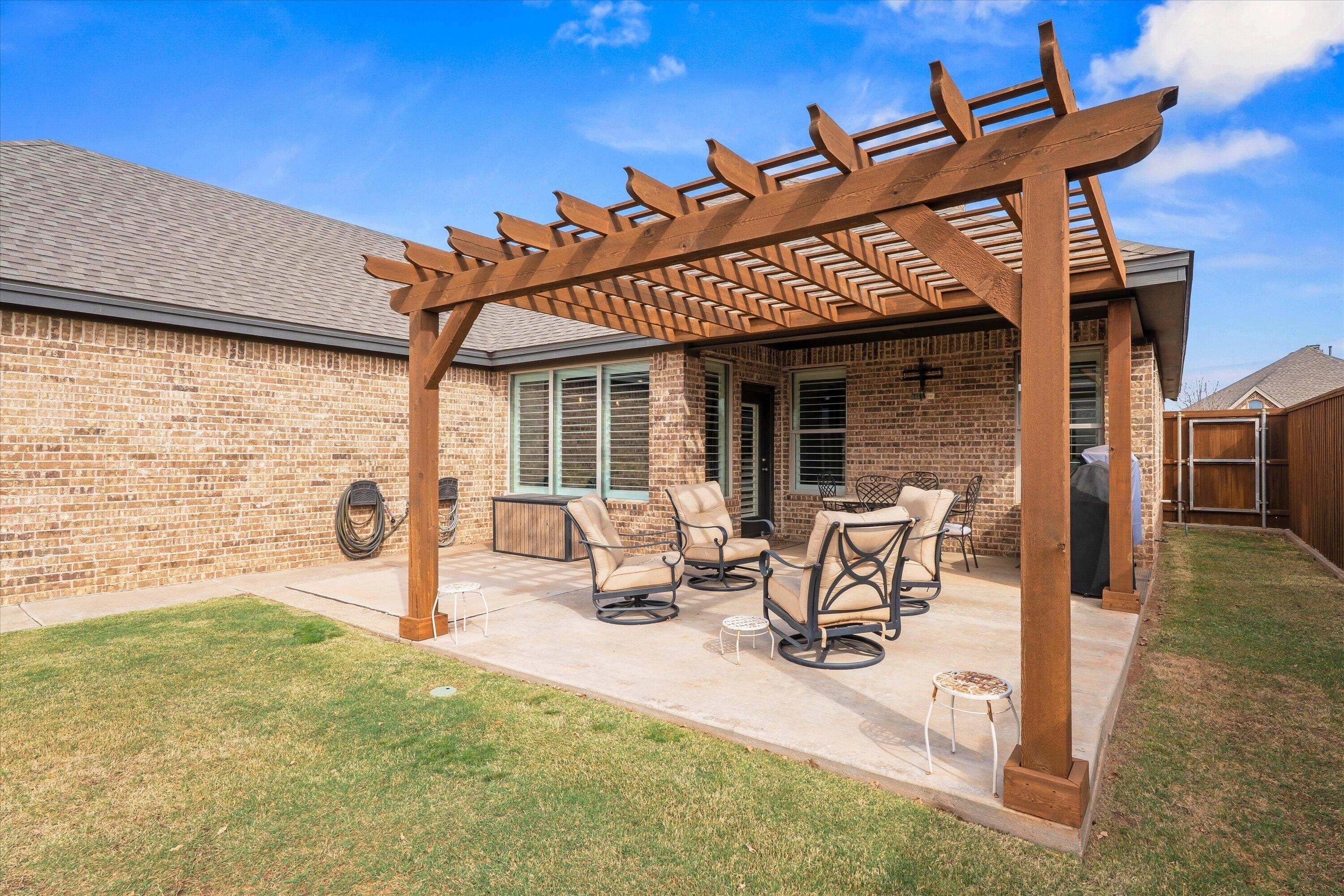 7033 101st Street Lubbock, TX 79424 - Photo 32 of 38 a view of a patio with table and chairs and potted plants